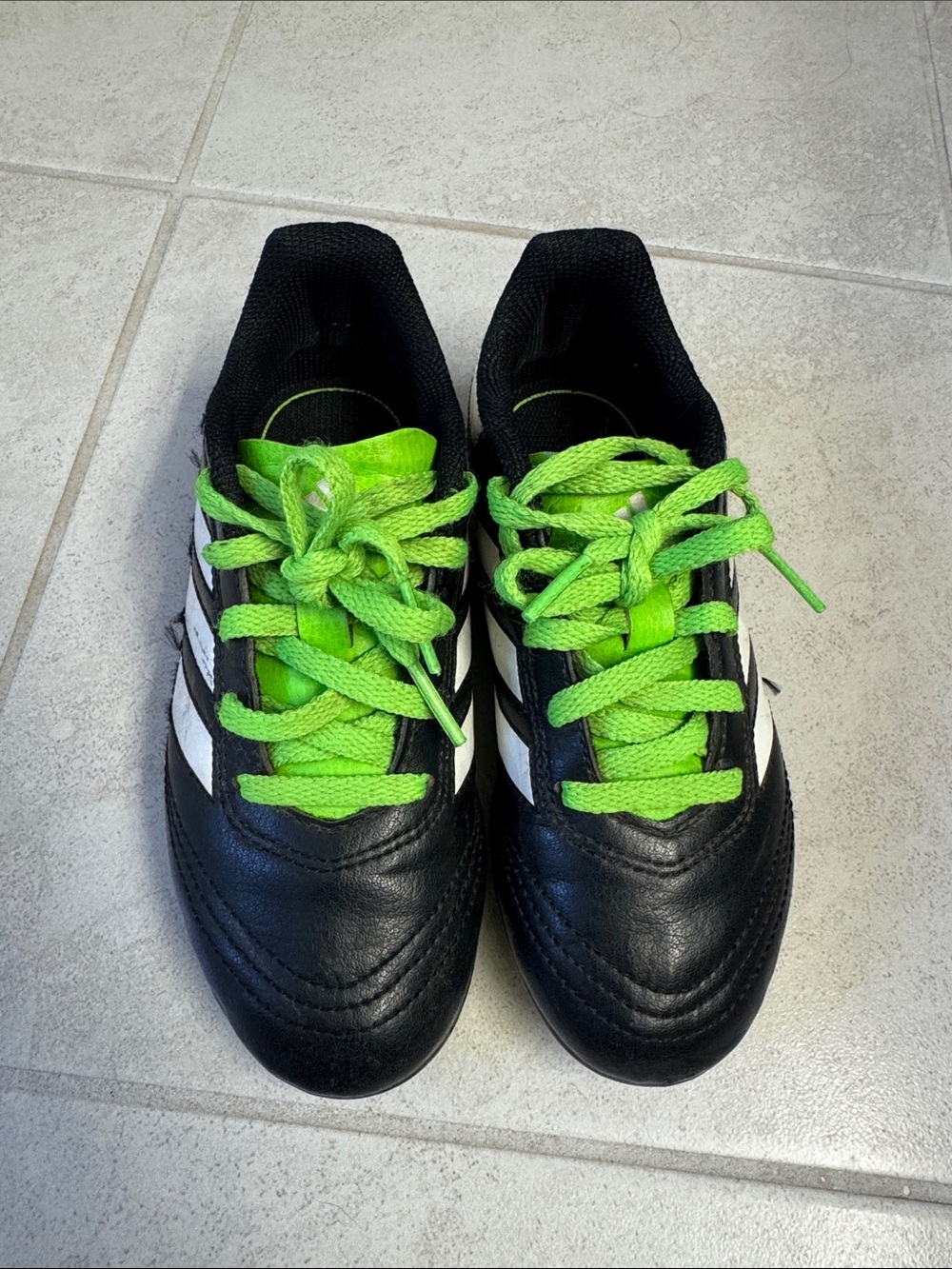 adidas Black Soccer Cleats with Neon Green Studs and White Stripes